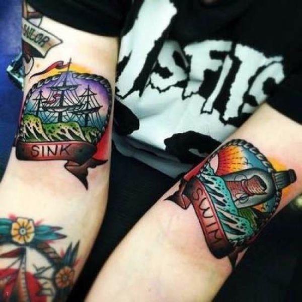 tattoo, Swim Or Sink traditional arm tattoo with the text, sink / swim
a ship on one side, and a message in a bottle on the other side, placed at the inside of the elbow